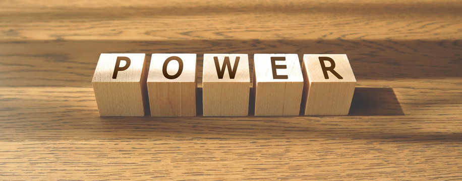 POWER word made of wooden cubes on a brown background. Business concept, positive thinking. Banner.