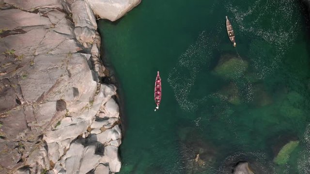 4k Aerial Top Down Shot of Two Paddle Boats  with tourists going on a boat ride in the Crystal Clear Waters  towards the river Current of Dawki, Meghalaya