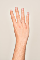 Hand of caucasian young man showing fingers over isolated white background counting number 4 showing four fingers