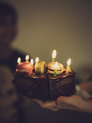 cake with candles in the hands