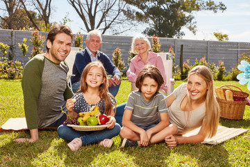 Family celebrates birthday with picnic in the garden