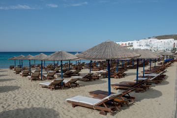 Beach chairs and umbrellas on an empty beach. Closed season 2020. 