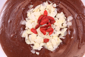 Chocolate Pudding Garnished with Almonds and Goji Berries. Top View