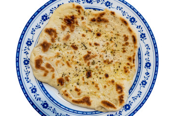 Handmade greek Pita with oregano and oil.
Traditional greek bread.
Isolated on white background.