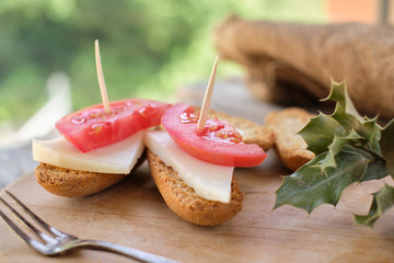 Tapas of semi-cured cheese with tomato