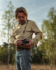 Nature photographer in nature reserve at sunrise during spring.