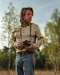 Nature photographer in nature reserve at sunrise during spring.