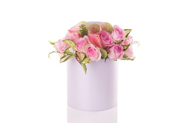 a bouquet of flowers in a round box on a white background