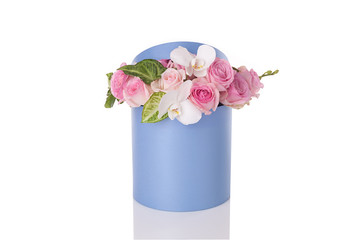 a bouquet of flowers in a round box on a white background