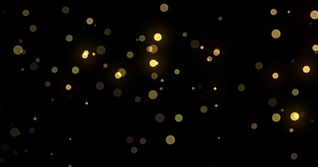 Light bokeh gold shine glitter background, abstract blur. Golden yellow glitter particle flares effect. Bright glowing shiny light bokeh sparkles on black background
