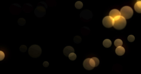 Bokeh light background, gold shine abstract blur flare effect. Golden yellow glitter particle flares with bright glowing shiny bokeh light sparkles on black background