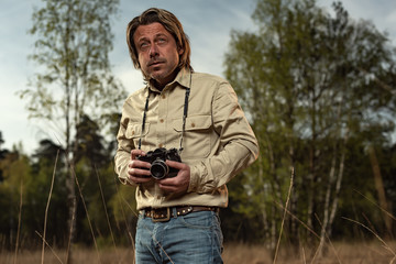 Nature photographer in nature reserve at sunrise during spring.