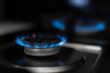 Gas stove, gas is burning. Gas burner on a dark background