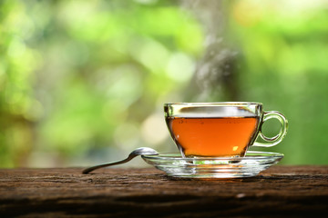 Morning cup of tea with smoke on nature background