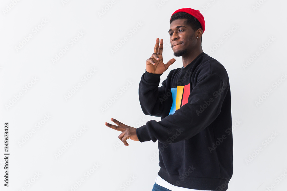 Wall mural youth street fashion concept - portrait of confident sexy black man in stylish sweatshirt on white b - Wall murals