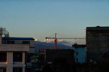 KATHMANDU/ NEPAL - MAY 4 2020- Obstructed view of the mountain on 42nd day of nationwide lockdown and halted construction worksite post the rain clearing the sky.