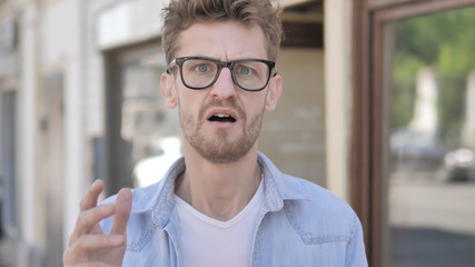 Upset Casual Young Man Disliking Results, Outdoor