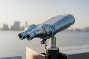 telescope with city skyline