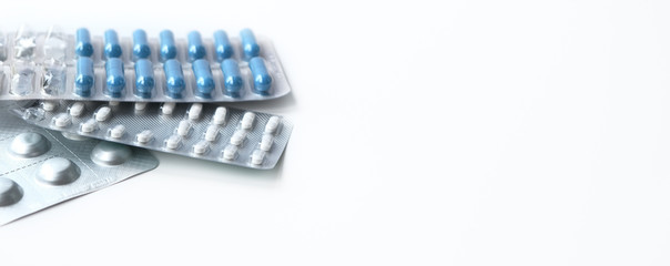 Medical topic. long banner on white background. blue and white pills in package