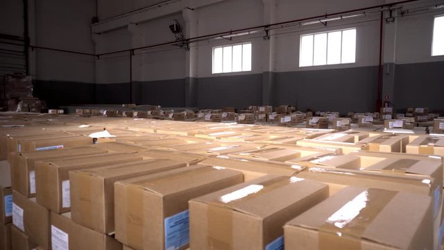Parcels and parcels in cardboard boxes at the customs control warehouse. The concept of excess prices for parcels from abroad, the limit on parcels, postal items, business