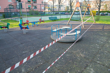 No entry barrier tape in a playground, due to the quarantine restrictions activated to combat the Coronavirus pandemic