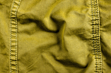 clothing items stonewashed cotton fabric texture with seams, clasps, buttons and rivets, macro