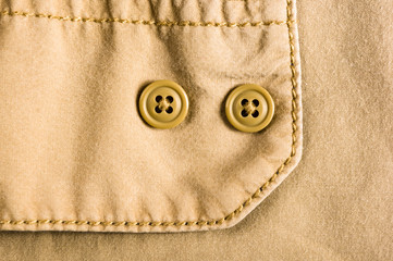 clothing items stonewashed cotton fabric texture with seams, clasps, buttons and rivets, macro