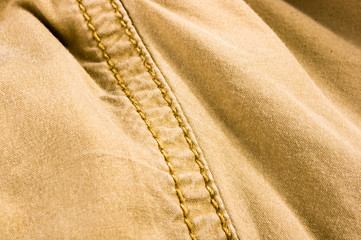 clothing items stonewashed cotton fabric texture with seams, clasps, buttons and rivets, macro