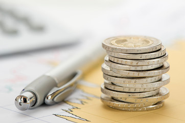 finance with stack of euro coins and calculator