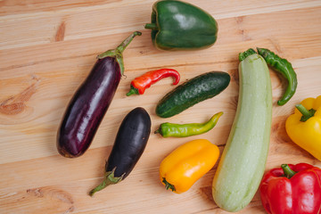 Cooking vegetables. Assortment of vegetables. Delicious homemade cucumber, paprika, zucchini, eggplant on the wooden table
