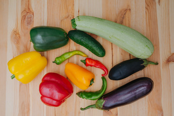 Cooking vegetables. Assortment of vegetables. Delicious homemade cucumber, paprika, zucchini, eggplant on the wooden table
