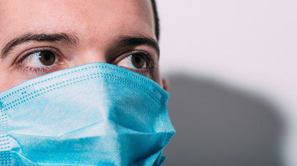 Boy with protective mask for virus and pollution looking at camera. White background with copy...