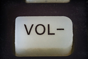 Extreme closeup of volume button on TV remote