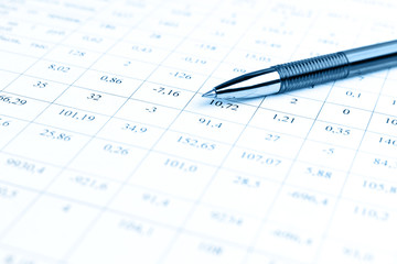 Accounting business concept. Close-up pen at financial report with numbers.