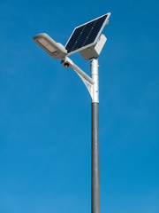 Fototapeta na wymiar solar panel and lamppost on a cloudless blue sky