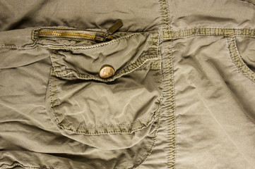 clothing items stonewashed cotton fabric texture with seams, clasps, buttons and rivets, macro