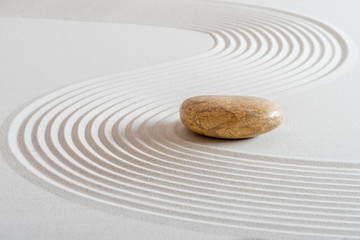 Fototapeta na wymiar japanese garden with stone in textured sand