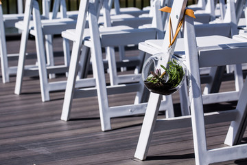 wedding ceremony aisle with chairs and flowers