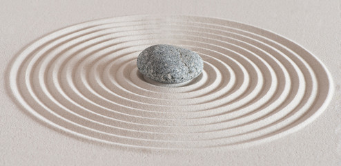 Fototapeta na wymiar japanese garden with stone in textured sand