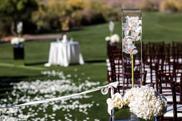 wedding ceremony aisle with chairs and flowers