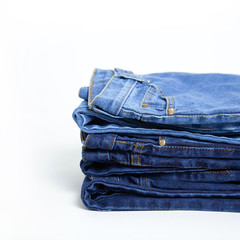 Jeans trousers stack on white background.