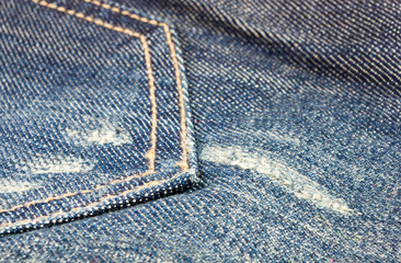 clothing items blue stonewashed faded jeans cotton fabric texture with seams, clasps, buttons and...
