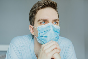 Young male mask in quarantined house due to coronavirus pandemic