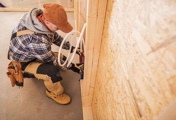 Caucasian Male Plumber Connects Water Pipes.