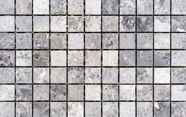 Ceramic mosaic tiles with gray and white embossed squares to decorate the kitchen, bathroom or pool.