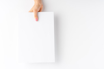 Female hand showing empty paper sheet. Close up