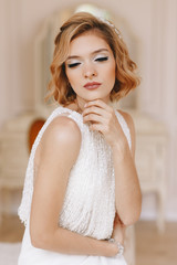 Portrait of the bride. Young girl, blonde with a short haircut. Close-up, vintage. Beautifully poses