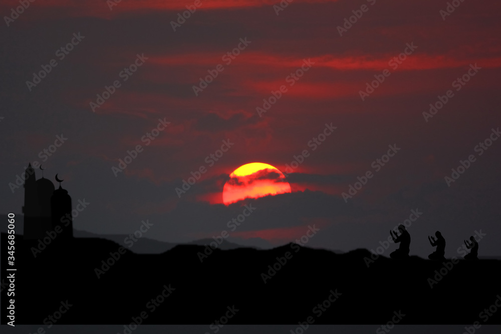 Wall mural the silhouette muslim moaque with sun set or sun rise beauty sky background with muslim people pray 