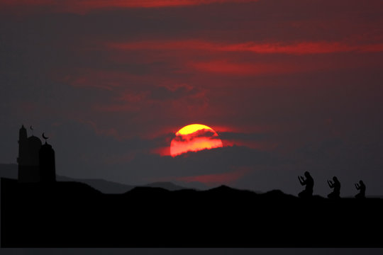 the silhouette muslim moaque with sun set or sun rise beauty sky background with muslim people pray in namaz time.