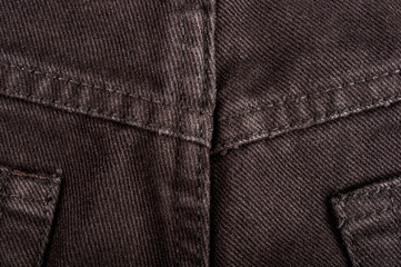 clothing items stonewashed cotton fabric texture with seams, clasps, buttons and rivets, macro